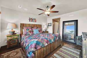 Bedroom featuring wood finished floors, a ceiling fan, and access to outside