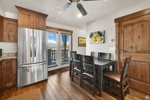 Dining area featuring dark wood-style flooring, recessed lighting, and ceiling fan