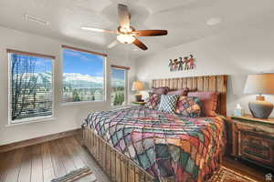 Bedroom featuring a textured ceiling, hardwood / wood-style floors, and ceiling fan