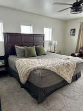 Bedroom with a textured ceiling and carpet flooring
