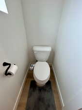 Bathroom with wood finished floors and baseboards