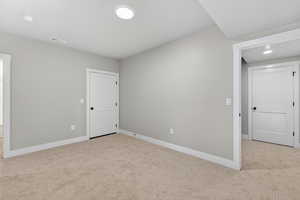 Carpeted empty room featuring baseboards