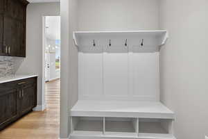 Mudroom with a chandelier and light wood-type flooring