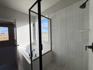 Full bathroom with a garden tub, tiled shower, and tile patterned flooring