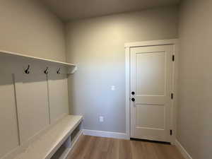 Mudroom with light wood-style flooring and baseboards