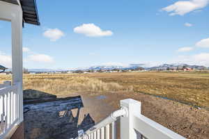 View of yard with a rural view and a mountain view