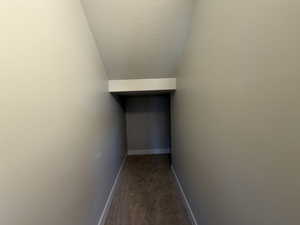 Interior space featuring a textured ceiling, carpet, and lofted ceiling