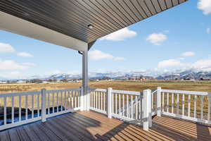 Deck featuring a mountain view and a view of rural / pastoral area