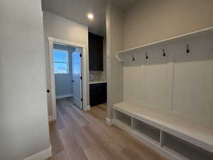 Mudroom with baseboards and light wood finished floors