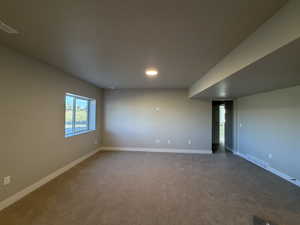 Unfurnished room with carpet and baseboards