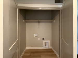 Laundry area with hookup for a washing machine, wood finished floors, and hookup for an electric dryer