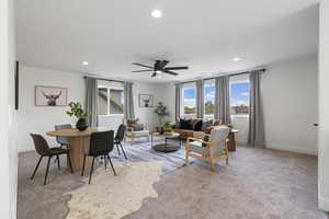 Living area with carpet floors, ceiling fan, and recessed lighting