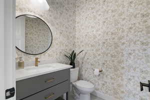 Bathroom featuring vanity and wallpapered walls