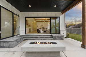 Patio terrace at dusk with a patio area and an outdoor fire pit