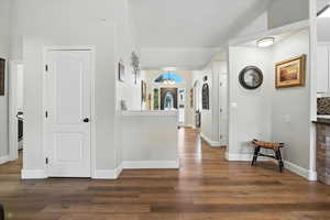 Corridor with wood finished floors and baseboards
