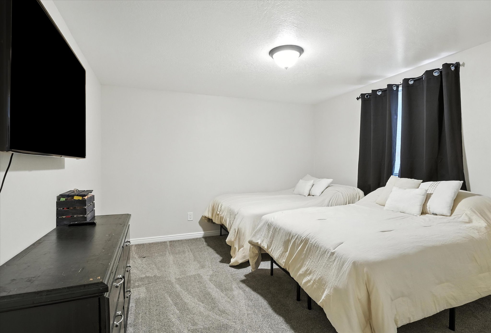 Bedroom featuring light colored carpet and baseboards