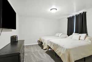 Bedroom featuring light colored carpet and baseboards