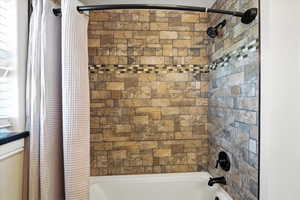 Full bath featuring shower / bathtub combination with curtain