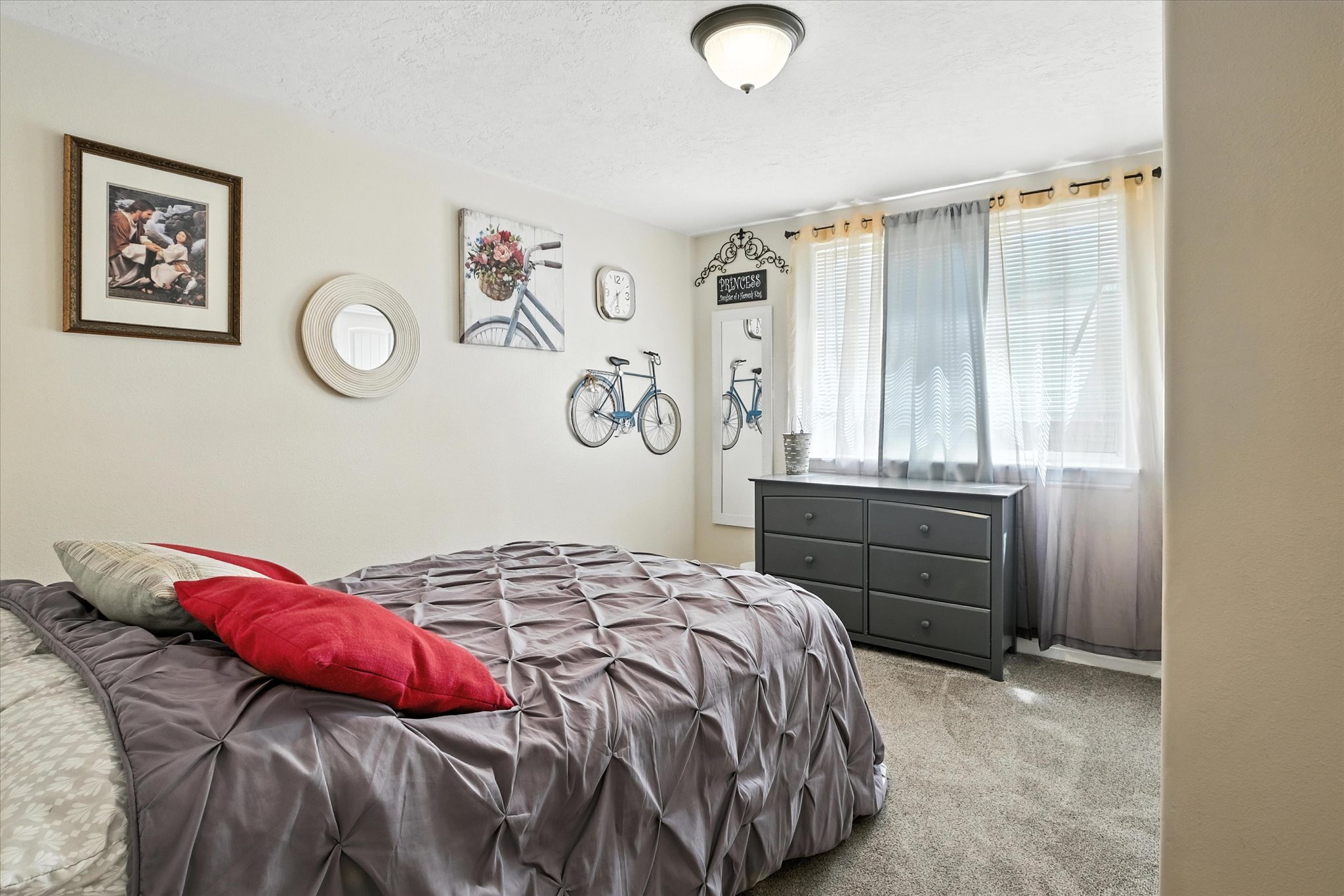 Bedroom featuring light carpet and a textured ceiling