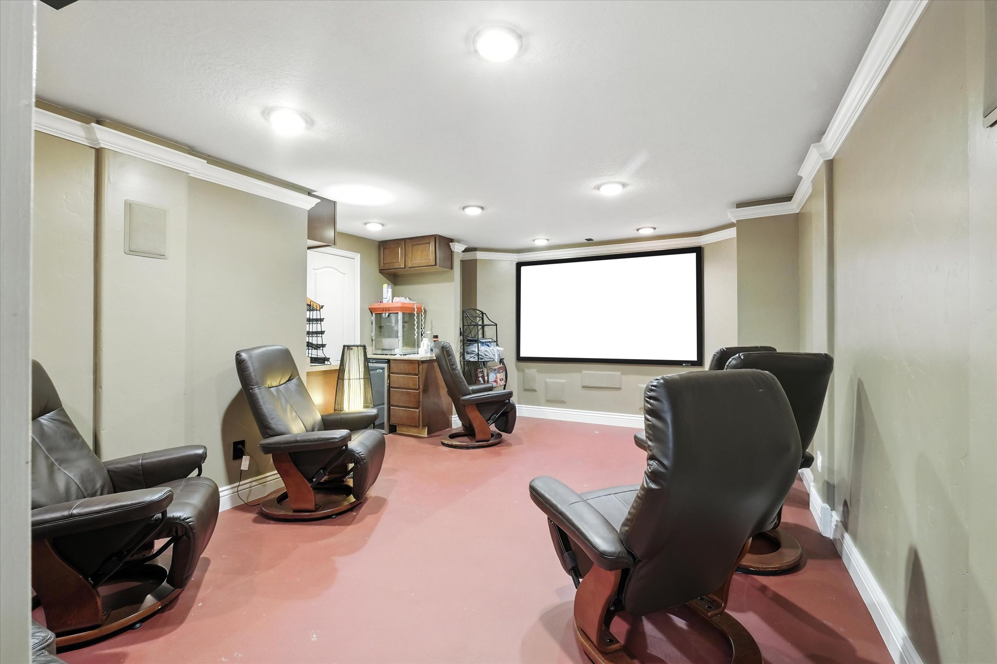 Cinema featuring ornamental molding and recessed lighting