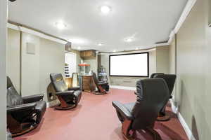 Cinema featuring ornamental molding and recessed lighting