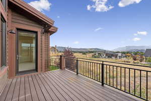 Wooden terrace featuring a residential view and a mountain view