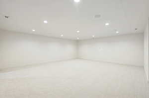 Spare room with light carpet and recessed lighting