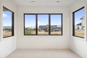 Spare room with light carpet and a mountain view