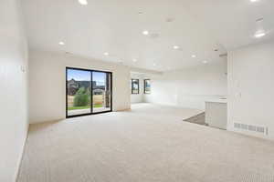 Spare room with light carpet and recessed lighting