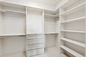 Spacious closet featuring light tile patterned flooring