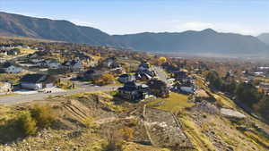 Aerial overview of property's location featuring nearby suburban area and a mountain backdrop