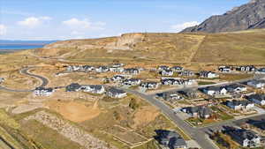 Aerial view of property's location with nearby suburban area and a mountain backdrop