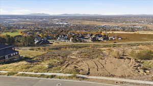 Aerial view of property's location featuring nearby suburban area and mountains
