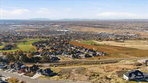 Aerial overview of property's location with nearby suburban area and mountains