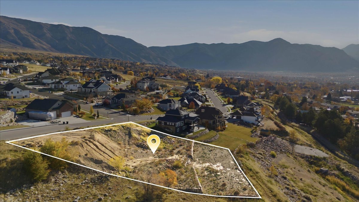 Aerial view of property's location featuring nearby suburban area and property parcel outlined
