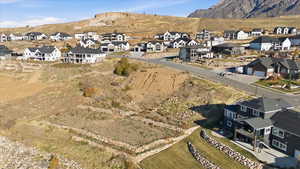 Aerial view of property and surrounding area with nearby suburban area and a mountainous background