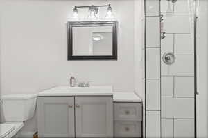 Bathroom featuring vanity and a shower