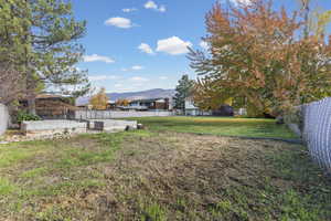 Fenced backyard with a mountain view
