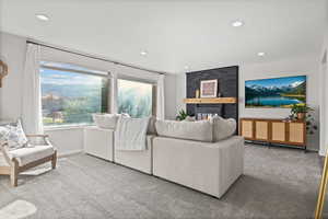 Carpeted living area with recessed lighting and baseboards