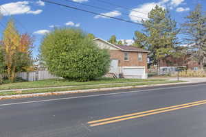 View of front of home featuring brick siding and a garage