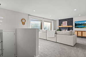 Living area with carpet flooring and recessed lighting