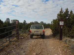 View of dirt / gravel road with a gated entry