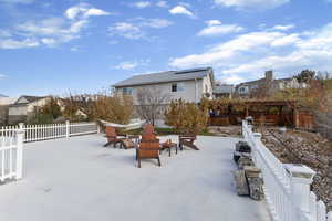Fenced backyard featuring an outdoor fire pit and a patio area