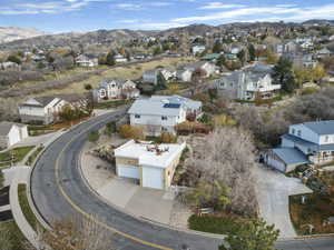 Aerial view of residential area featuring a mountainous background