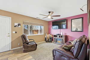 Living area with ceiling fan, carpeted floors