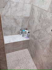 Bathroom featuring a tile shower