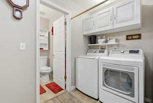 Laundry room featuring cabinet space, and separate washer and dryer