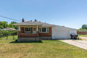 View of front of property with brick siding, concrete driveway, and a porch