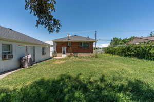 Rear view of property featuring brick siding