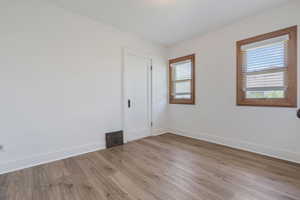 Empty room featuring baseboards and wood finished floors